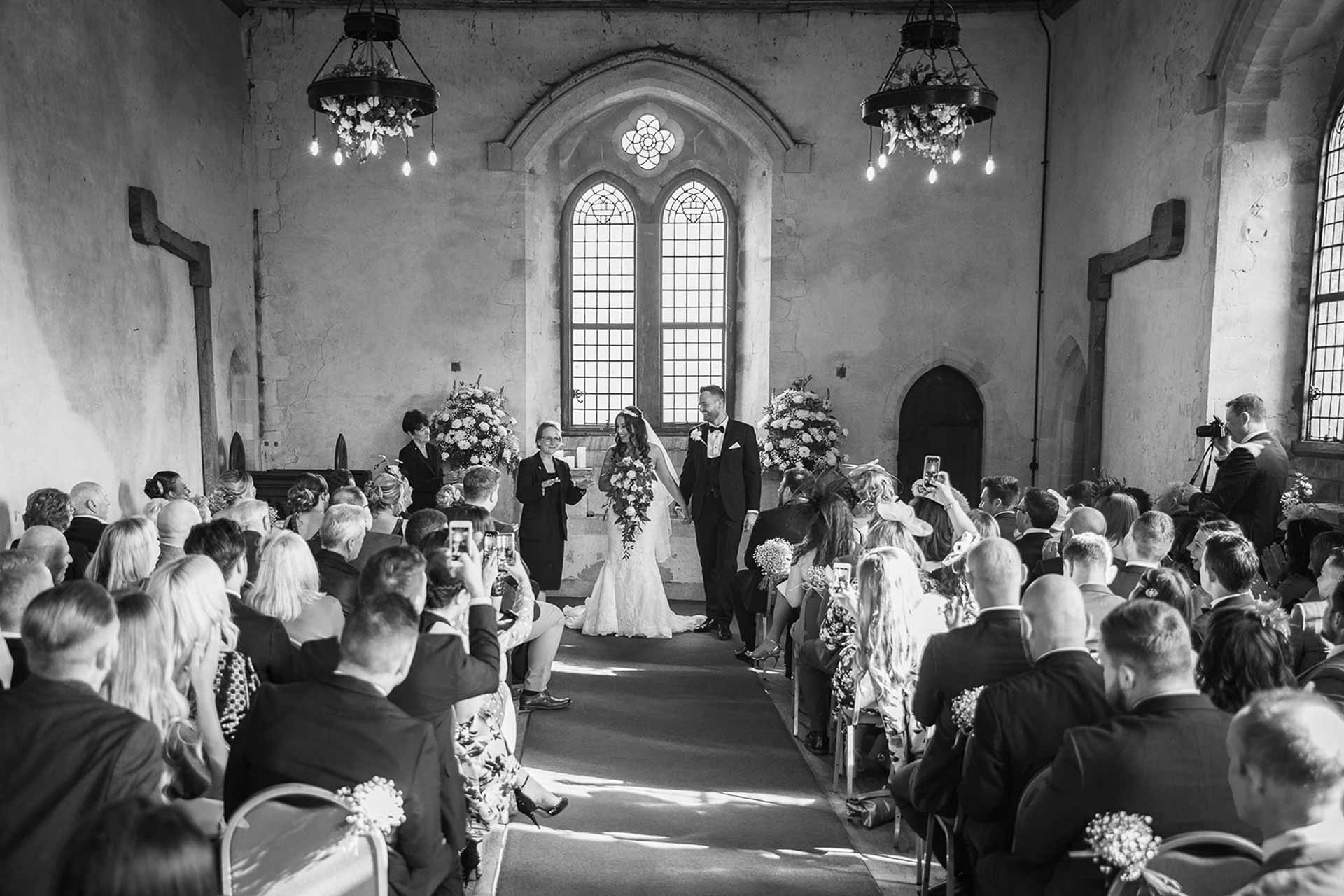An indoor wedding in the Great Hall of Bilsington Priory
