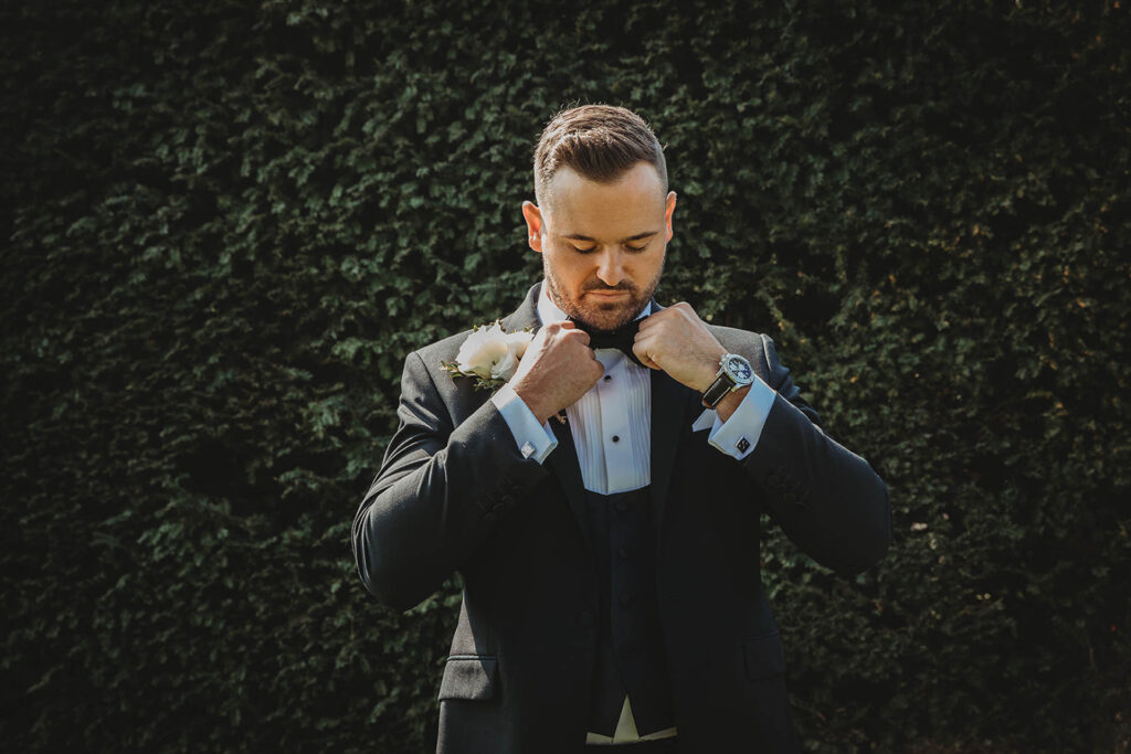 A groom adjusting his dickie bow at Bilsington Priory