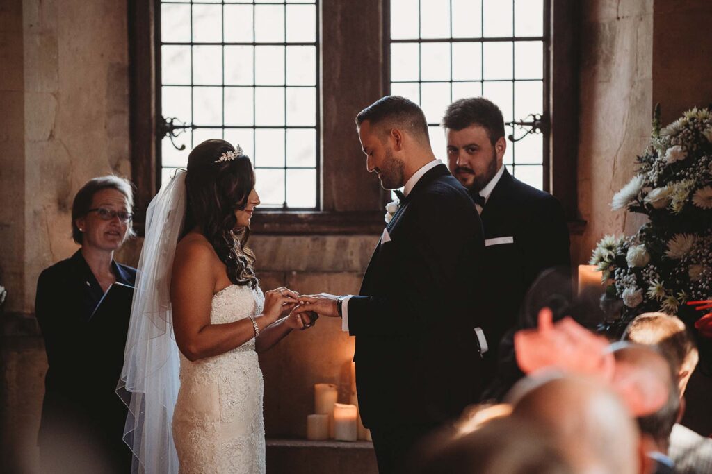 A couple exchange rings in the Great Hall of Bilsington Priory near Ashford
