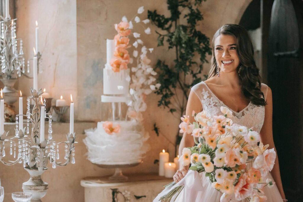 A bride with her bouquet in the Great Hall of Bilsington Priory Kent